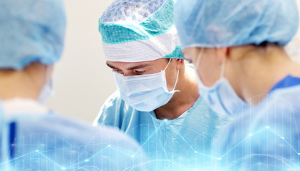 Fototapeta premium group of surgeons in operating room at hospital