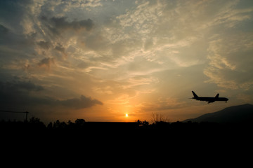 Fototapeta na wymiar Airplane Landing with Yellow sky sunset background