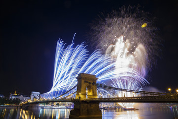 Fireworks in the night sky of Budapest. View of the illuminated Chain Bridge