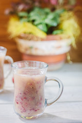 Grape smoothie over the white table.