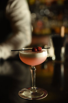 Pink cocktail with raspberries on straw 