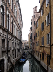 venice canal and buildings in muted colours bridge and moored boats © philopenshaw