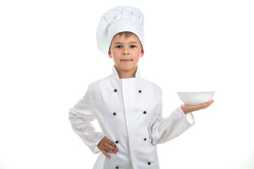 A kid with an empty plate on his hand wearing chef uniform, isolated on white background.