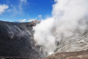 Volcano crater spewing smoke at Mount Bromo Tengger Semeru National park in East Java, Indonesia.