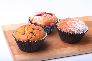 Homemade Blueberry muffins with powdered sugar and fresh berries.