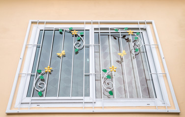 Pattern of curved steel (wrought iron) on a glass window.
