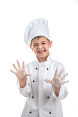 Cute playful little chef with flour on his hands