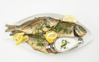 Grilled Fish with Lemon Slices, Grilled seafood served on plate isolated on white