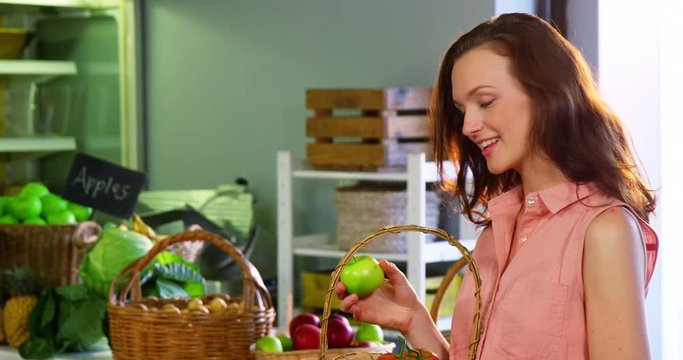 Woman selecting green apple