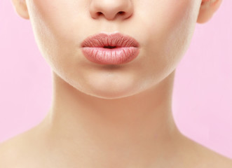 Fototapeta premium Closeup view of beautiful young woman with natural lips makeup on color background