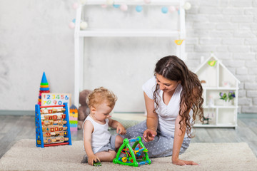 mother and her son play together indoor