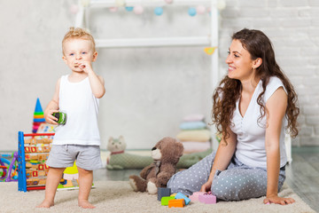 mother and her son play together indoor