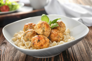 Bowl with turkey meatballs and pasta on table, closeup
