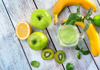 Mason jar of fresh juice on wooden background