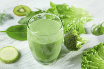 Glass of fresh juice on wooden background