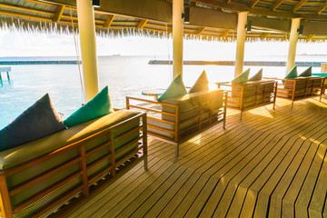 Vacation seat in tropical Maldives island and beauty of the sea with the coral reefs . ( Filtered image processed vintage effect. )