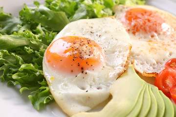 Delicious breakfast with fried eggs on plate
