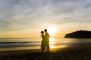 A couple holding hands during an amazing sunset. Loving couple in the pond at sunset hug