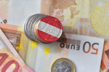 euro coin with national flag of austria on the euro money banknotes background