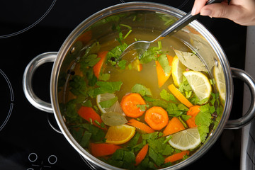 Woman preparing brine for turkey in cooking pot