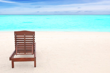 Sun lounger on beach in summer day