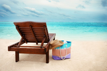 Fototapeta na wymiar Sun lounger with beach accessories at sea resort