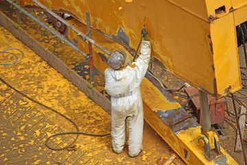 Fototapeta na wymiar Paint stripping in a shipyard