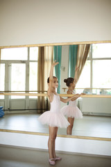 Little ballerina in ballet studio