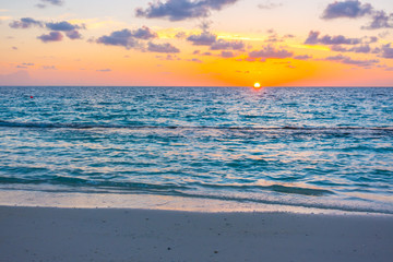 Beautiful sunset with sky over calm sea  in tropical Maldives island