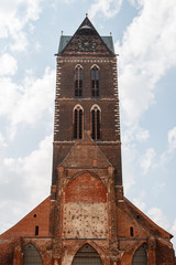 Fototapeta premium Clock tower of the gothic church in Wismar old town, Germany