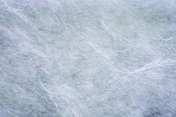 Close-up of an abstract white gauze background texture with vignetting.