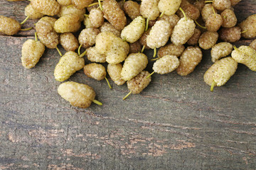 Sweet white mulberries on wooden table