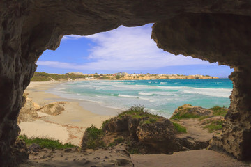 The most beautiful coast of Apulia: Torre Dell'Orso Bay, ITALY (Lecce).Typical seascape of Salento: view of the wide sandy beach of fine silver, the dune with pinewood and town.