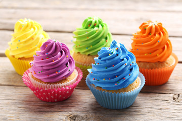 Tasty cupcakes on a grey wooden table