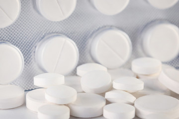 Heap of pills on white background