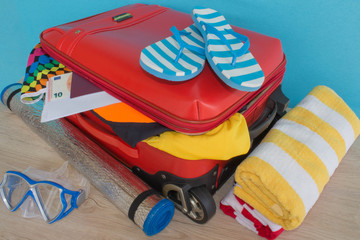 Suitcase with things for spending summer vacation. Anticipation of voyage. Women's clothes and accessories in suitcase