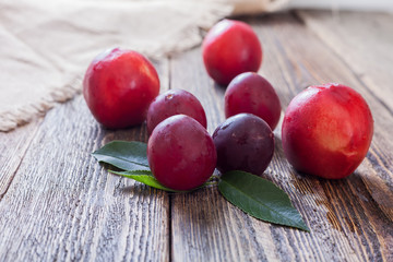 Nectarines and ripe plum on a wooden table