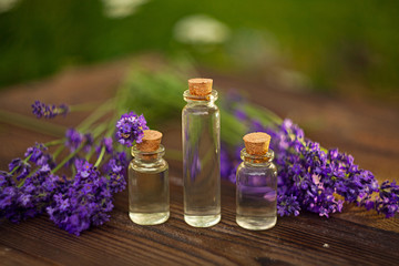 Essence of lavender flowers on table in beautiful glass jar