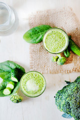 Summer nutritious and refreshing drink, detox, green vegetable smoothie from broccoli, spinach and cucumber on a light background