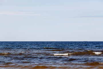 sunny summer scene of Baltic sea with beautiful seaside with waves.