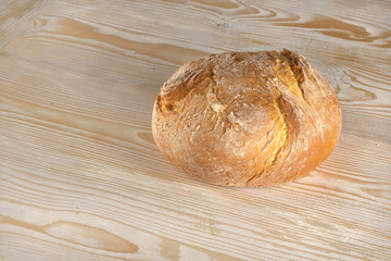 Fresh  bread  on  wooden table., Site view  with copy space