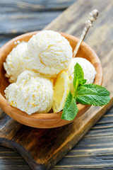 Homemade lemon ice cream in a wooden bowl.