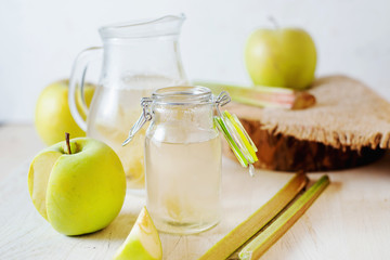 Summer refreshing drink, compote of apple and rhubarb on a light background