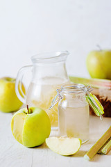 Summer refreshing drink, compote of apple and rhubarb on a light background