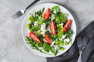 Fresh tomato salad in a grey ceramic plate. Diet or clean eating concept