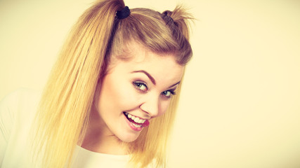 Happy blonde teenager girl with ponytails