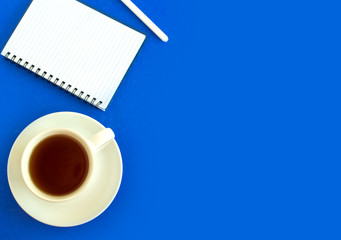 Obraz na płótnie Canvas blue table with a notepad for notes, a pen.
