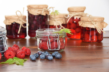 Sweet blueberries and raspberries in jars for winter