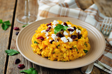Pumpkin risotto with dried cranberries and goat cheese