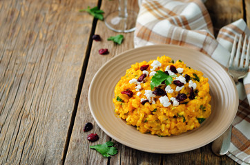 Pumpkin risotto with dried cranberries and goat cheese